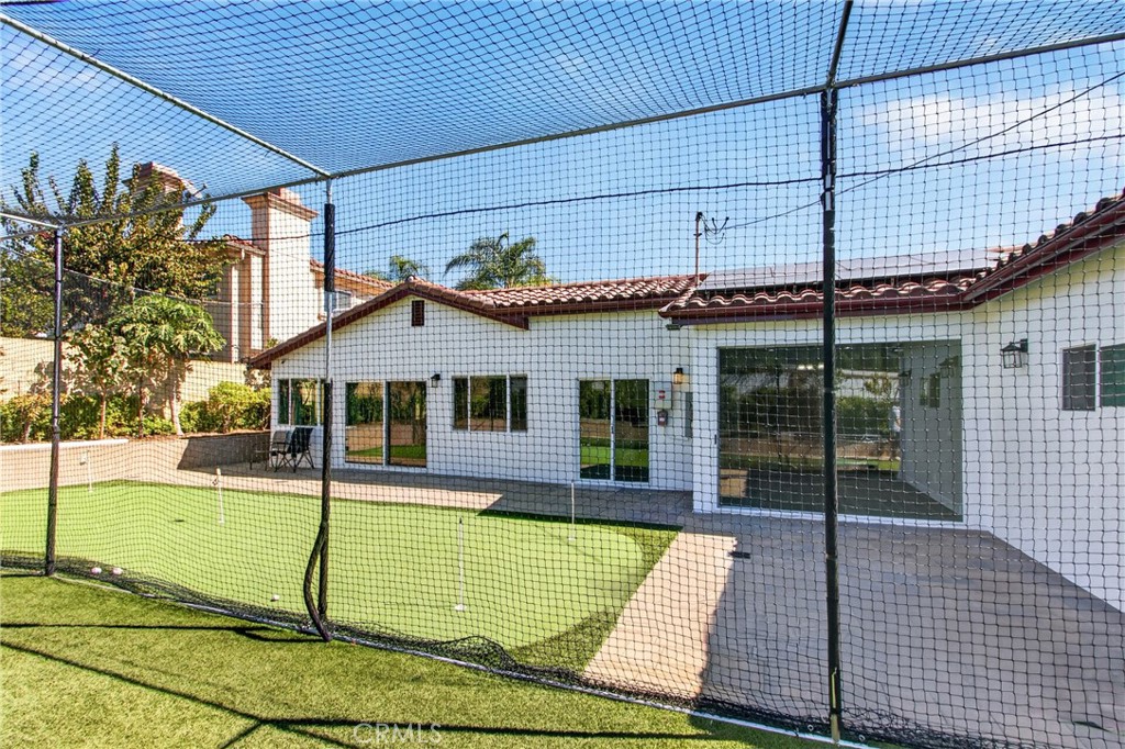 Batting practice cage with netting and turf, located in the backyard. - 5451 Lockhaven Drive, Buena Park CA 90621 - photo 34