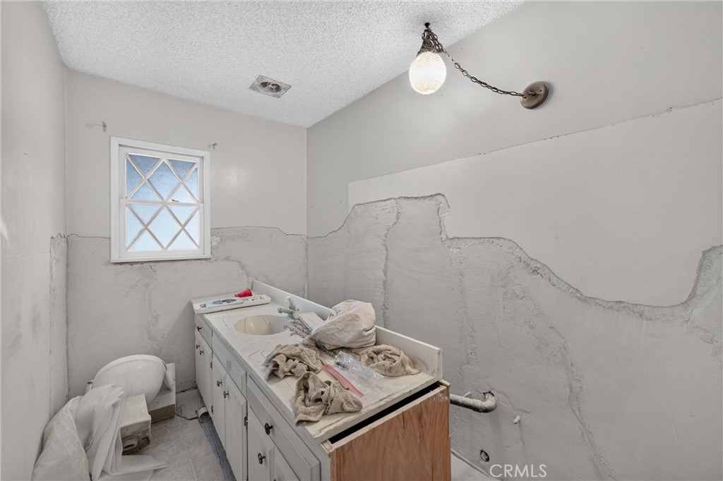 unfinished bathroom off of living room - 8721 Somerset, Buena Park CA 90621 - photo 36