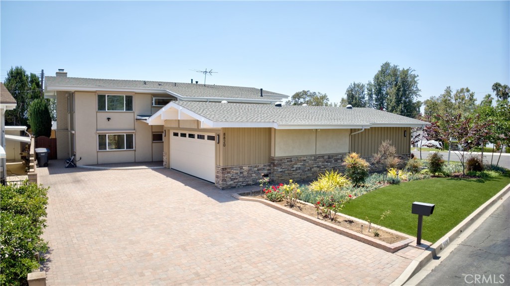 Street view of property with dual width paver driveway - 8820 Meadowbrook, Buena Park CA 90621 - photo 1