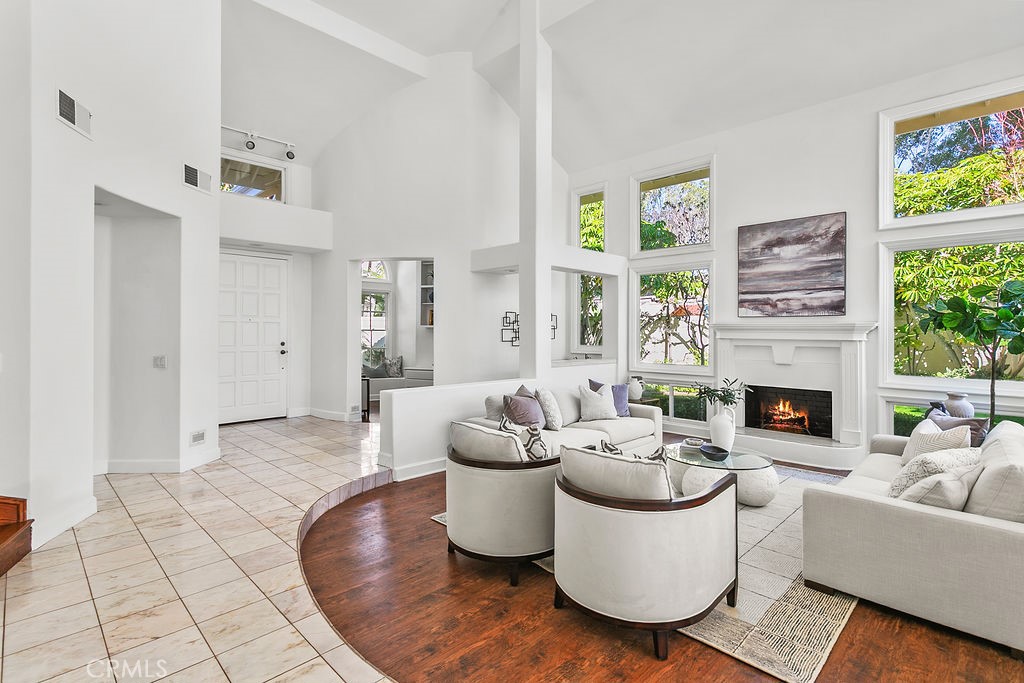 View of front entry from the living room. Fire in fireplace virtually created. - 19 Harbor Pointe, Corona Del Mar CA 92625 - photo 11