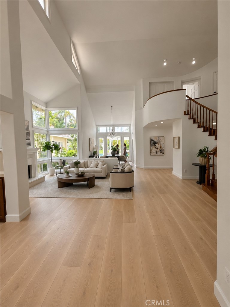 Ai generated view from entry through living room with flooring and elevation change plus new flooring and removal of pon - 19 Harbor Pointe, Corona Del Mar CA 92625 - photo 12