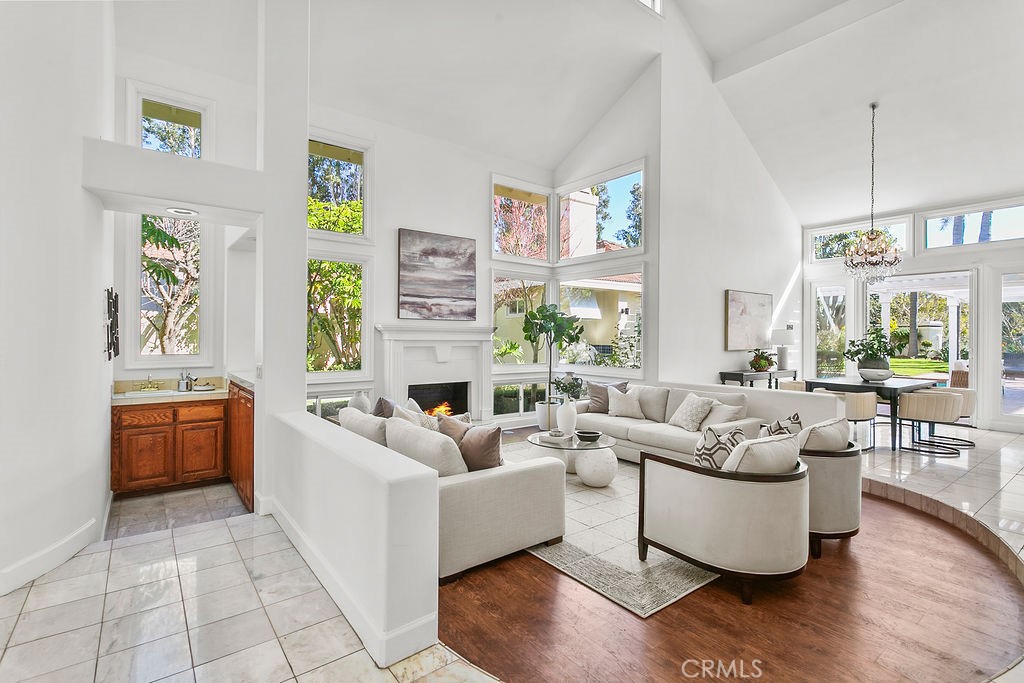 Dining room adjacent to the living room also has high ceilings and opens to the back yard. Fire in fireplace is virtuall - 19 Harbor Pointe, Corona Del Mar CA 92625 - photo 13