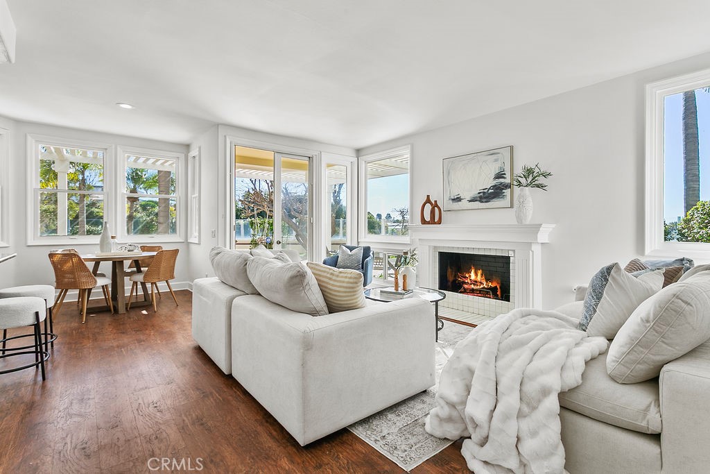 Family room is adjacent to breakfast.area, has a cozy fireplace and ocean view windows as well as access to the yards. F - 19 Harbor Pointe, Corona Del Mar CA 92625 - photo 17