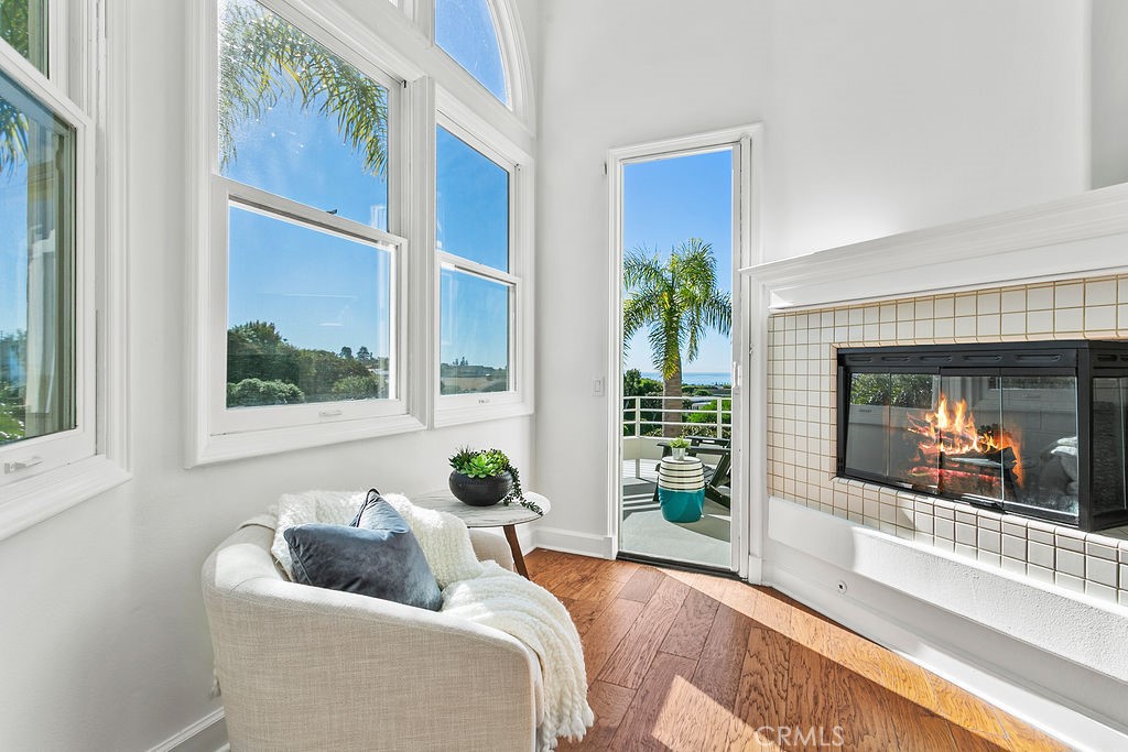Your primary bedroom sitting area faces the corner fireplace and is next to the door to your secluded ocean view balcony - 19 Harbor Pointe, Corona Del Mar CA 92625 - photo 30