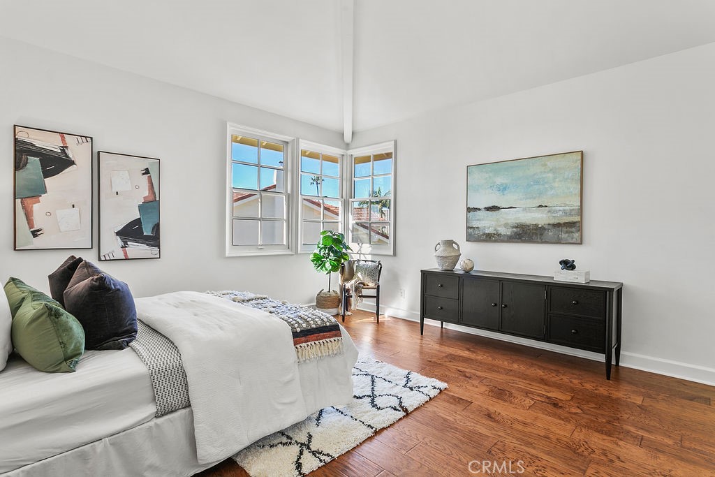 Secondary upstairs bedroom with vaulted ceiling and "peek a boo" view of Newport Center and the ocean. - 19 Harbor Pointe, Corona Del Mar CA 92625 - photo 33