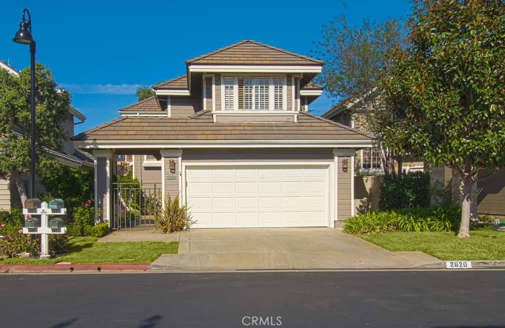 Front of home with a two car garage and direct access to the home. - 2620 Point Del Mar, Corona Del Mar CA 92625 - photo 1