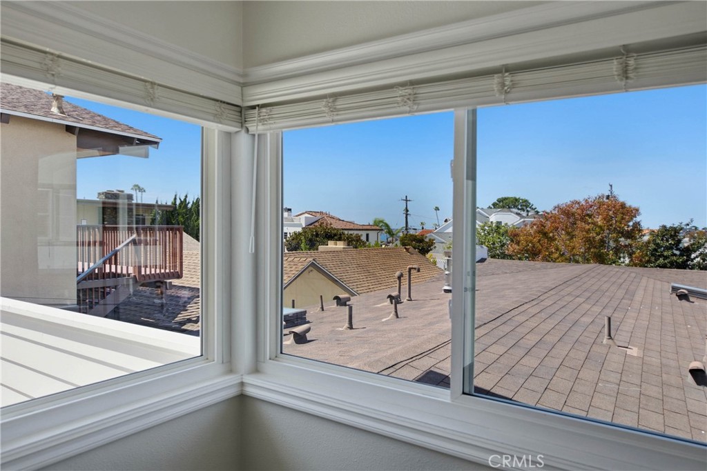 Peekaboo views of the ocean and coastline from the dining room. - 412 1/2 Dahlia Avenue, Corona Del Mar CA 92625 - photo 8