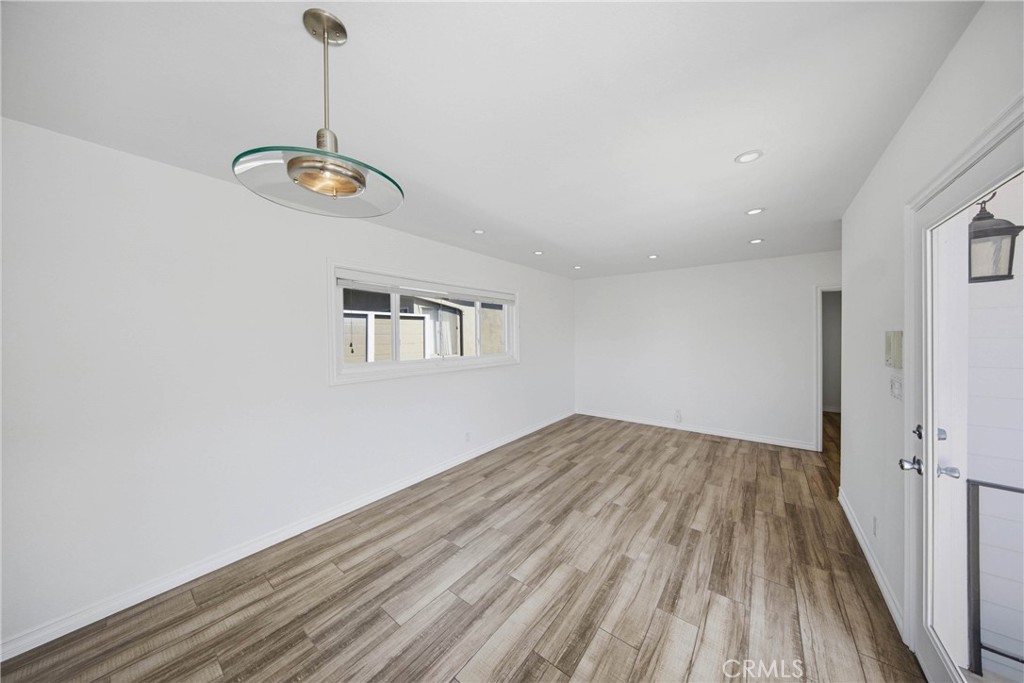 Open dining area pouring into the bright living​​‌​​​​‌​​‌‌​​‌‌​​‌‌​​‌​​​‌‌​‌​​​​‌‌​‌​​ room. - 412 1/2 Dahlia Avenue, Corona Del Mar CA 92625 - photo 9
