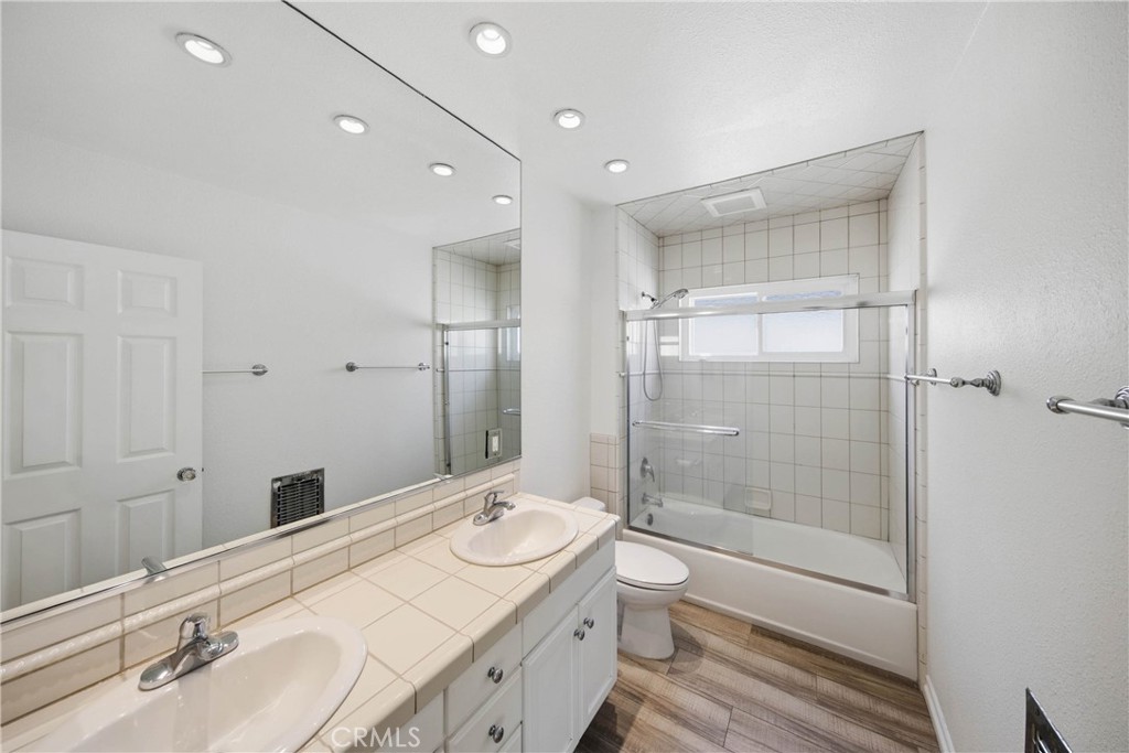 Primary bathroom featuring double sink and shower in tub. - 412 1/2 Dahlia Avenue, Corona Del Mar CA 92625 - photo 15
