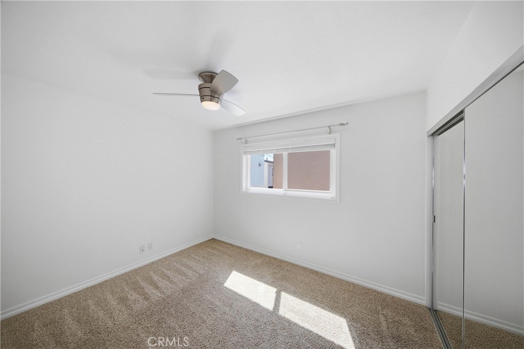 Second primary bedroom with ceiling fan and spacious closet. - 412 1/2 Dahlia Avenue, Corona Del Mar CA 92625 - photo 16