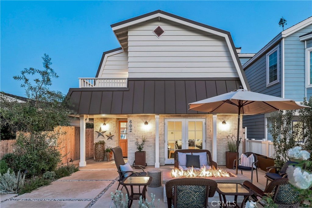This evening shot of the front of the duplex gives you a great view of the entertaining space that the property has to o - 602 602.5 Marguerite 2, Corona Del Mar CA 92625 - photo 4