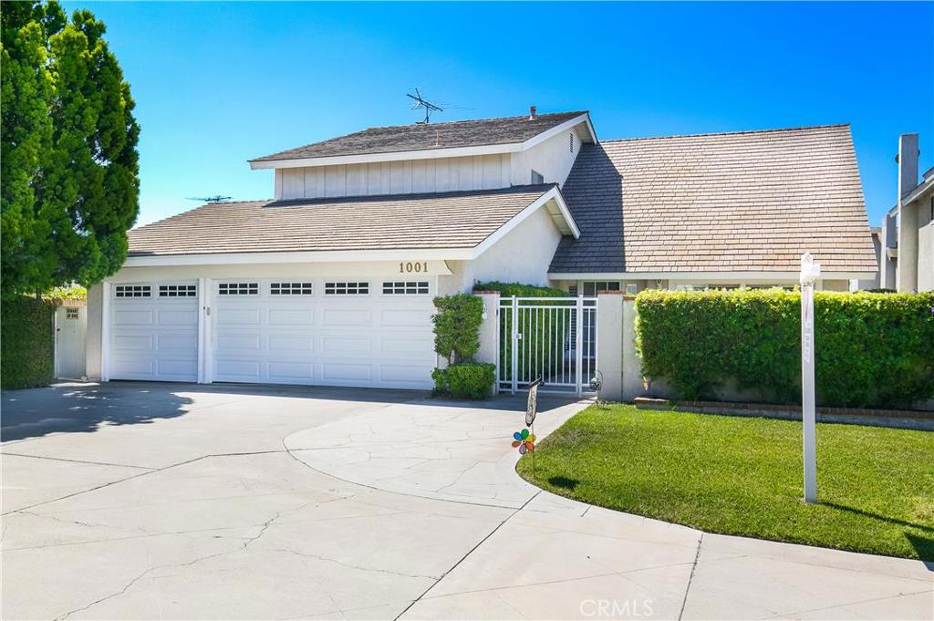 Extra wide driveway and three car garage with direct entry to house. - 1001 Cannonade Circle, Costa Mesa CA 92626 - photo 1