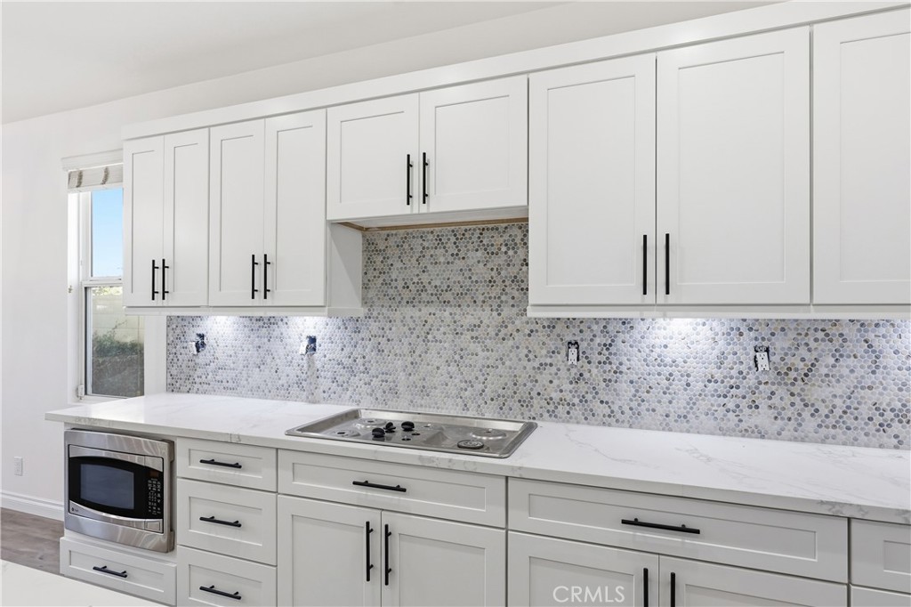New shaker style cabinets; new backsplash; new 5 burner stove and hood on order will be installed in a few days - 1044 Palmetto, Costa Mesa CA 92626 - photo 8