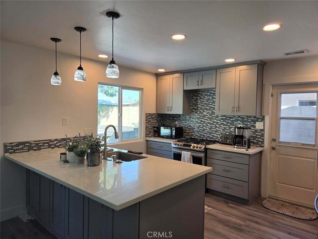 Kitchen with Island and door to the backyard. - 1628 White Oak, Costa Mesa CA 92626 - photo 2