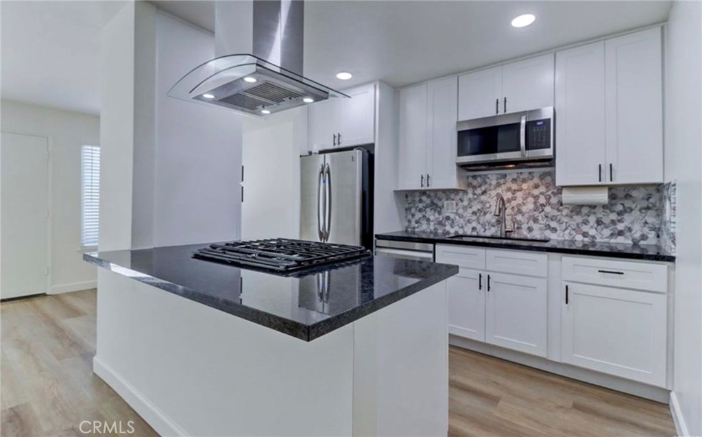 More photos coming soon. Modernized kitchen with open concept. Photo from prior to current tenant. - 1647 Iowa Street C, Costa Mesa CA 92626 - photo 1
