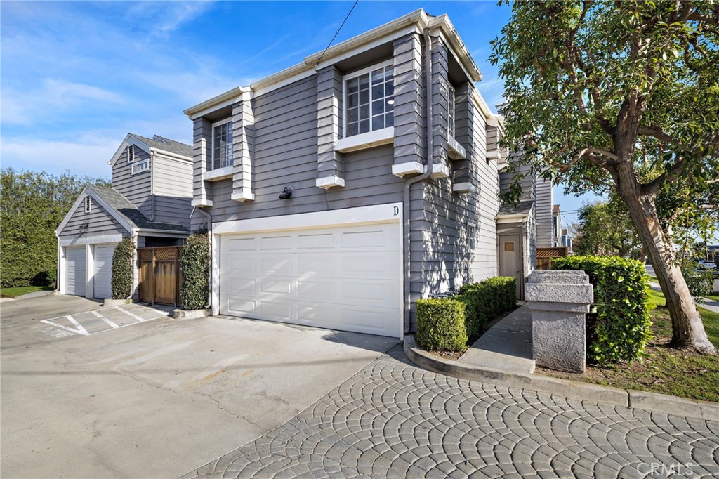 Townhome-style residence in a private four-home enclave featuring an attached two-car garage with direct access—set in E - 168 23rd D, Costa Mesa CA 92627 - photo 1