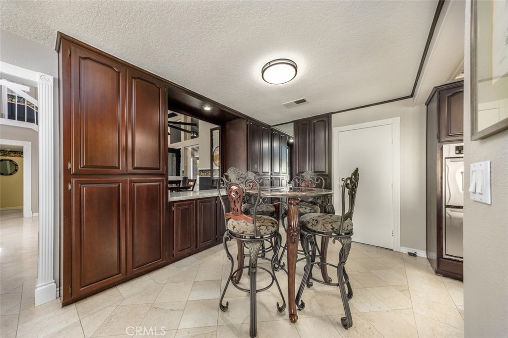 breakfast area. lots of cabinets - 1828 Kinglet Court, Costa Mesa CA 92626 - photo 13