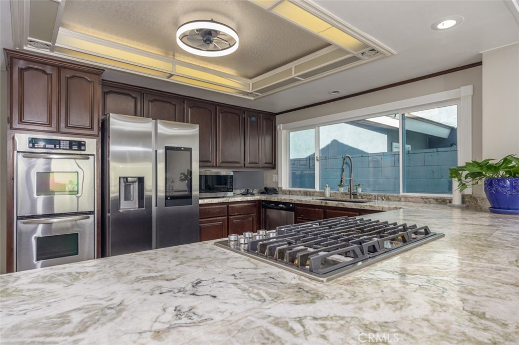 lovely kitchen with large cooktop and island - 1828 Kinglet Court, Costa Mesa CA 92626 - photo 14