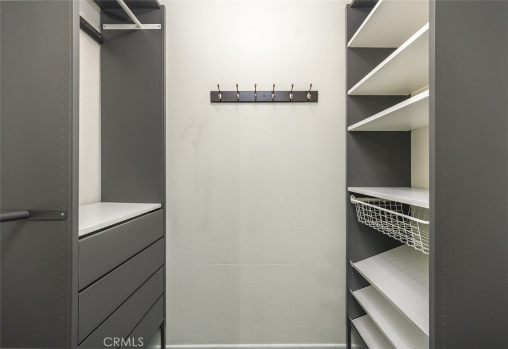 walk in closet middle bedroom - 1828 Kinglet Court, Costa Mesa CA 92626 - photo 45