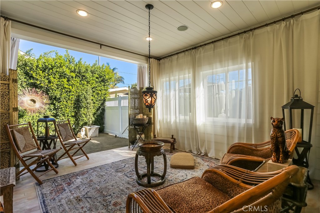 Off the kitchen, enjoy warm summer nights and afternoon ocean breezes in the enclosed covered patio, which is an approxi - 188 Merrill Place, Costa Mesa CA 92627 - photo 1