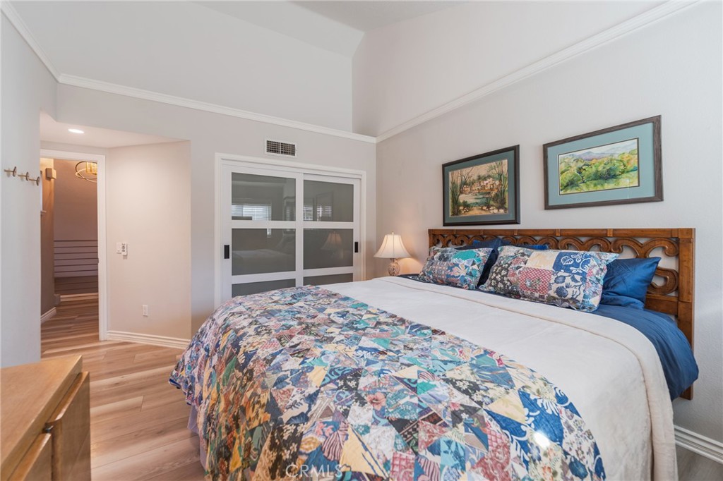 Primary bedroom with newer closet door and high ceilings - 2168 San Michel E B, Costa Mesa CA 92627 - photo 22
