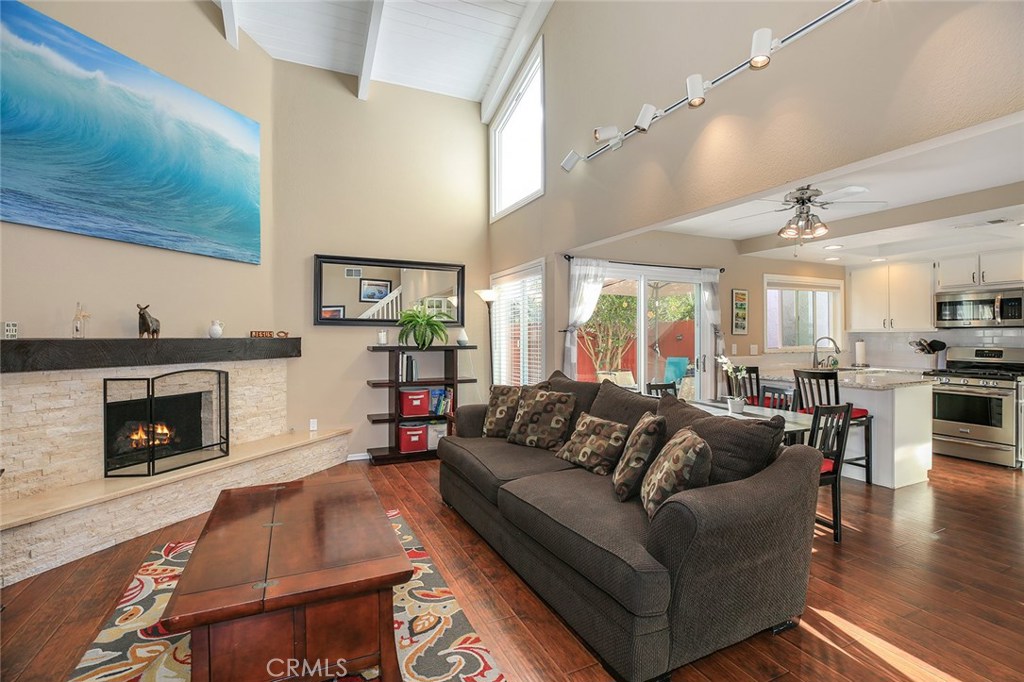 Beautifully upgraded and ready to move in! Gleaming wood laminate flooring throughout this wide open living space. High, - 2184 Canyon Drive 12, Costa Mesa CA 92627 - photo 1