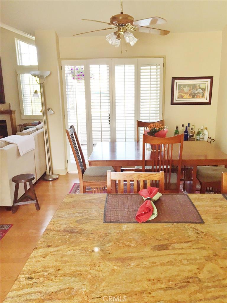 This is the view from the kitchen/breakfast bar out to the separate dining area and large balcony. Notice the plantation - 2210 Canyon Drive D1, Costa Mesa CA 92627 - photo 1