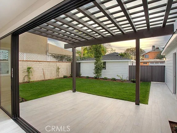 plank style tile floor patio off great room - 241 E 19th Street, Costa Mesa CA 92627 - photo 31