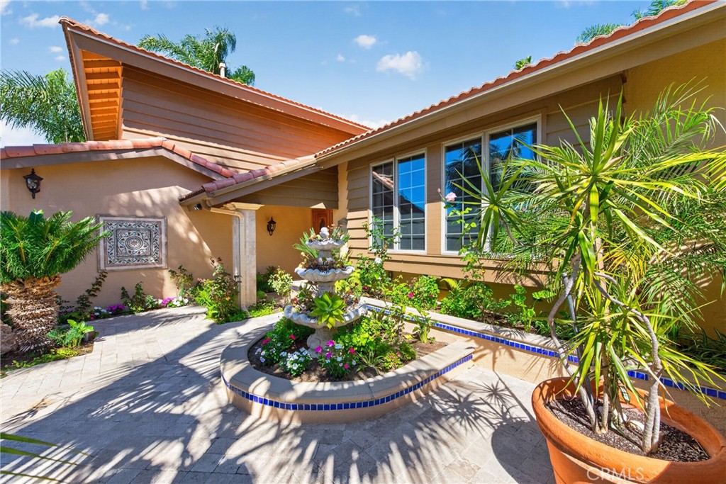 Gorgeous Courtyard entry with 3 level fountain and vibrant plants and flowers throughout. - 2740 Cardinal Drive, Costa Mesa CA 92626 - photo 3