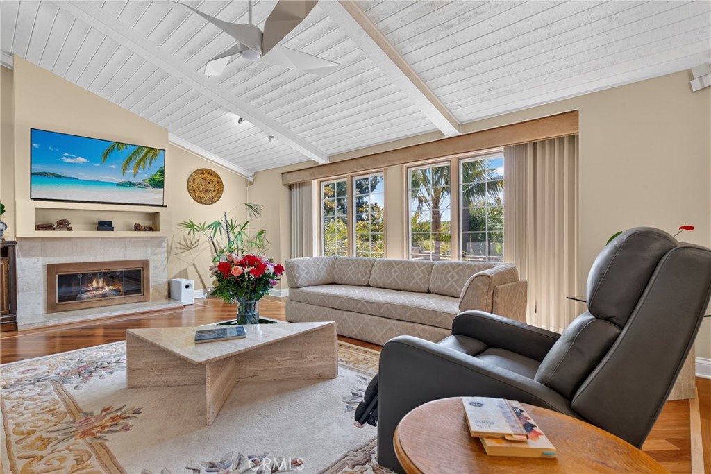 Vaulted living room with beamed ceiling and ceiling fan and fireplace - 2740 Cardinal Drive, Costa Mesa CA 92626 - photo 7