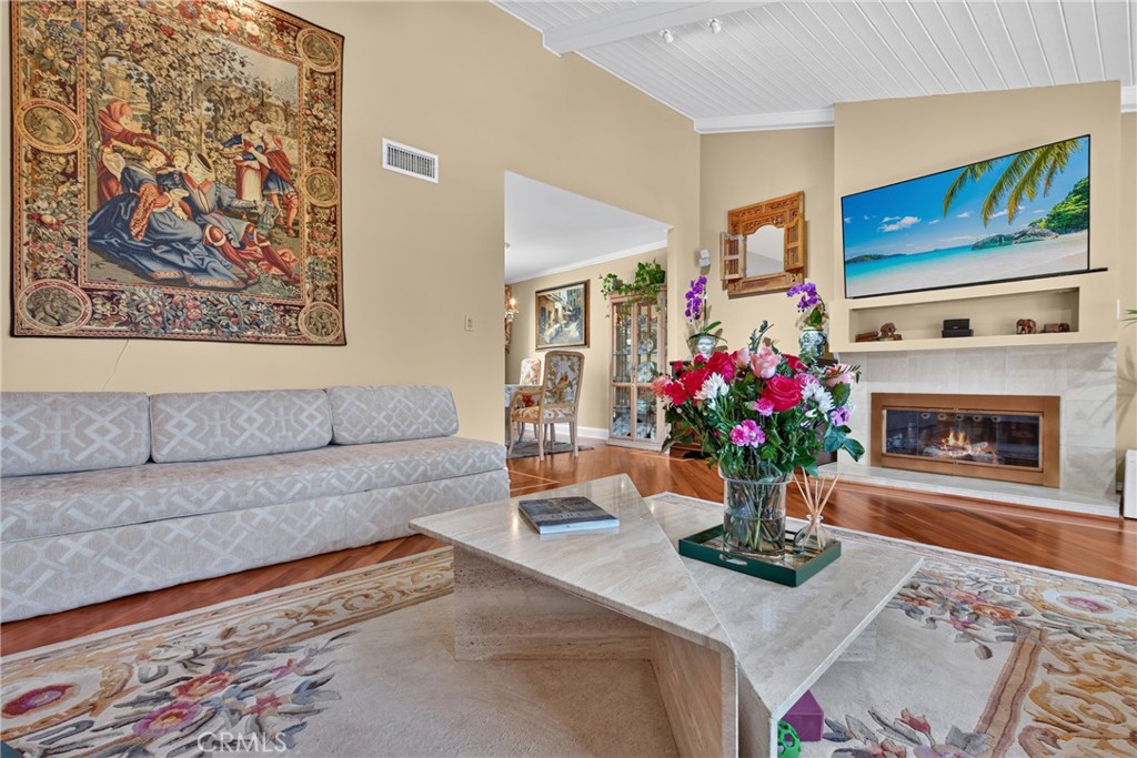 Vaulted living room with beamed ceiling and ceiling fan and fireplace - 2740 Cardinal Drive, Costa Mesa CA 92626 - photo 8