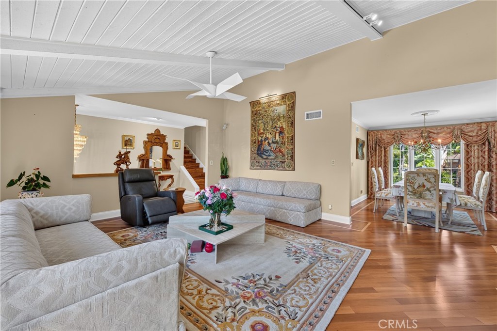 Vaulted living room with beamed ceiling and ceiling fan and fireplace - 2740 Cardinal Drive, Costa Mesa CA 92626 - photo 9