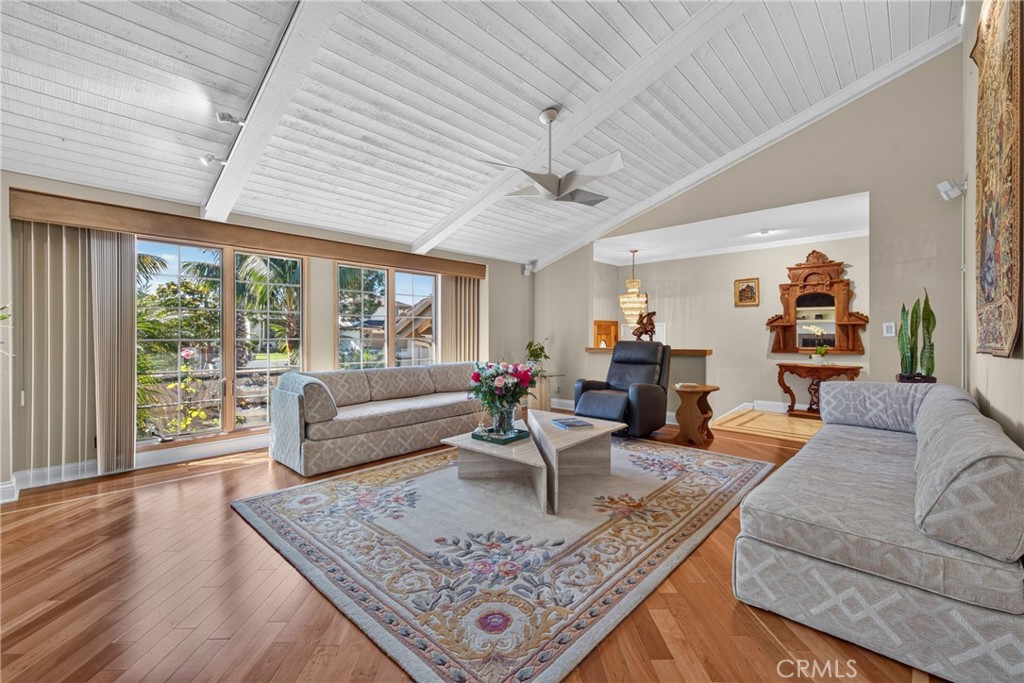 Vaulted living room with beamed ceiling and ceiling fan and fireplace - 2740 Cardinal Drive, Costa Mesa CA 92626 - photo 10