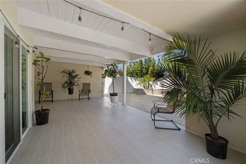 The covered patio serves as a secondary living room and could easily house a TV. - 2750 San Carlos, Costa Mesa CA 92626 - photo 39