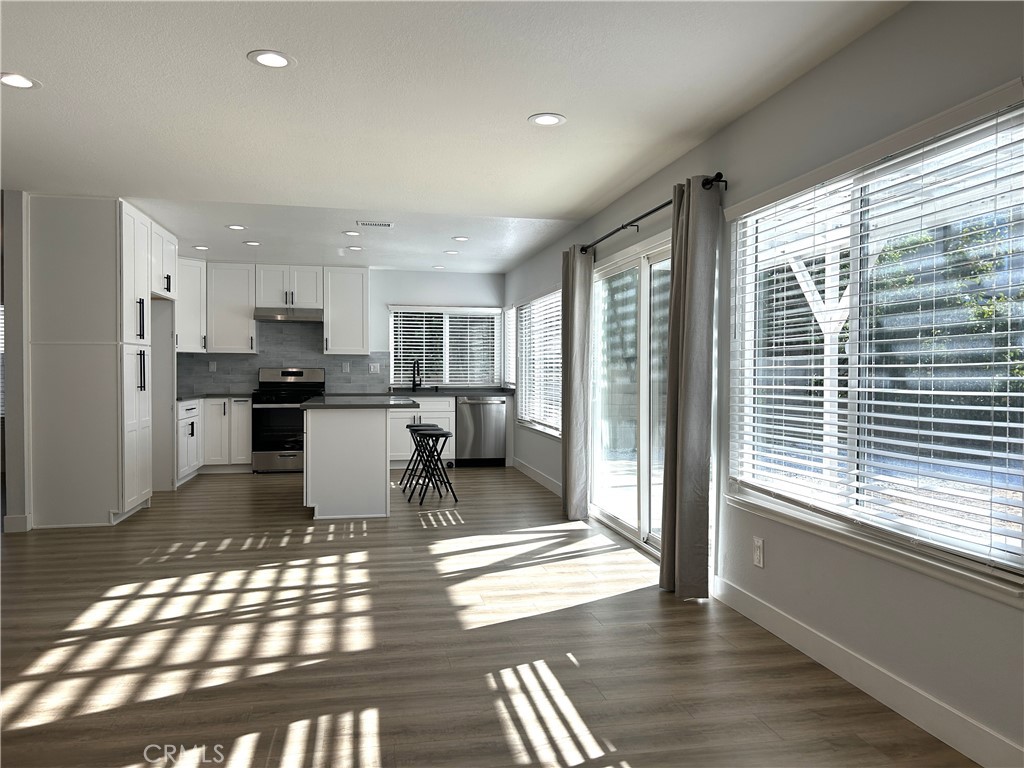 Sun-filled living and dining space overlooking the backyard - 3475 Fuchsia, Costa Mesa CA 92626 - photo 3