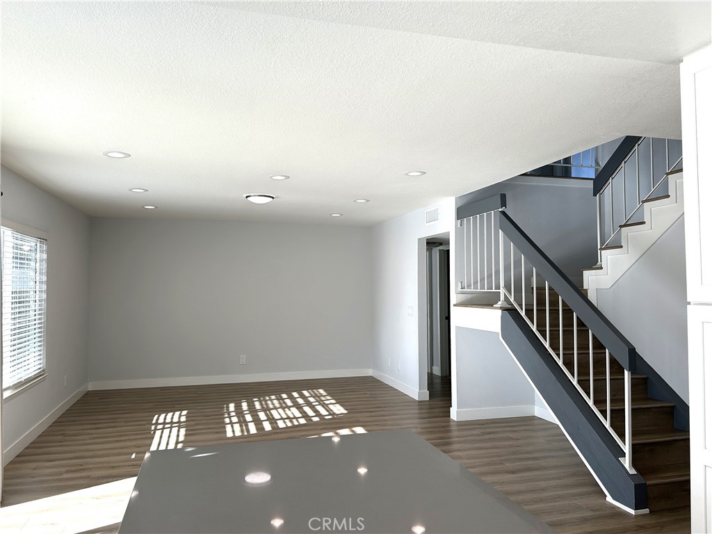 Bright and spacious living area with an open staircase - 3475 Fuchsia, Costa Mesa CA 92626 - photo 5