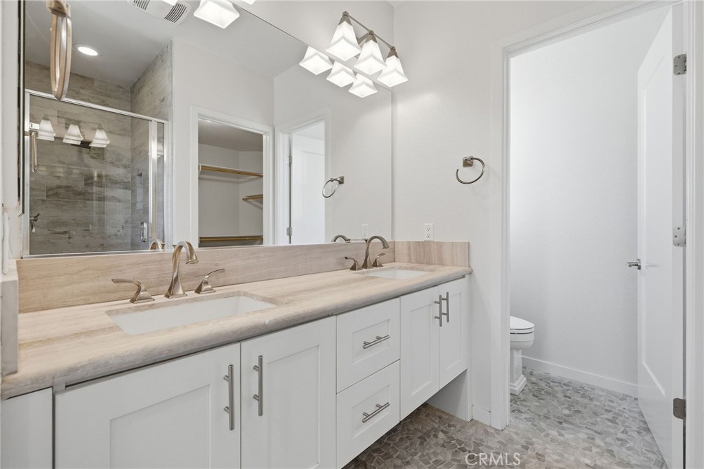 Primary bathroom with dual sinks, large walk in shower and walk in closet - 783 Wonder Lane, Costa Mesa CA 92627 - photo 10