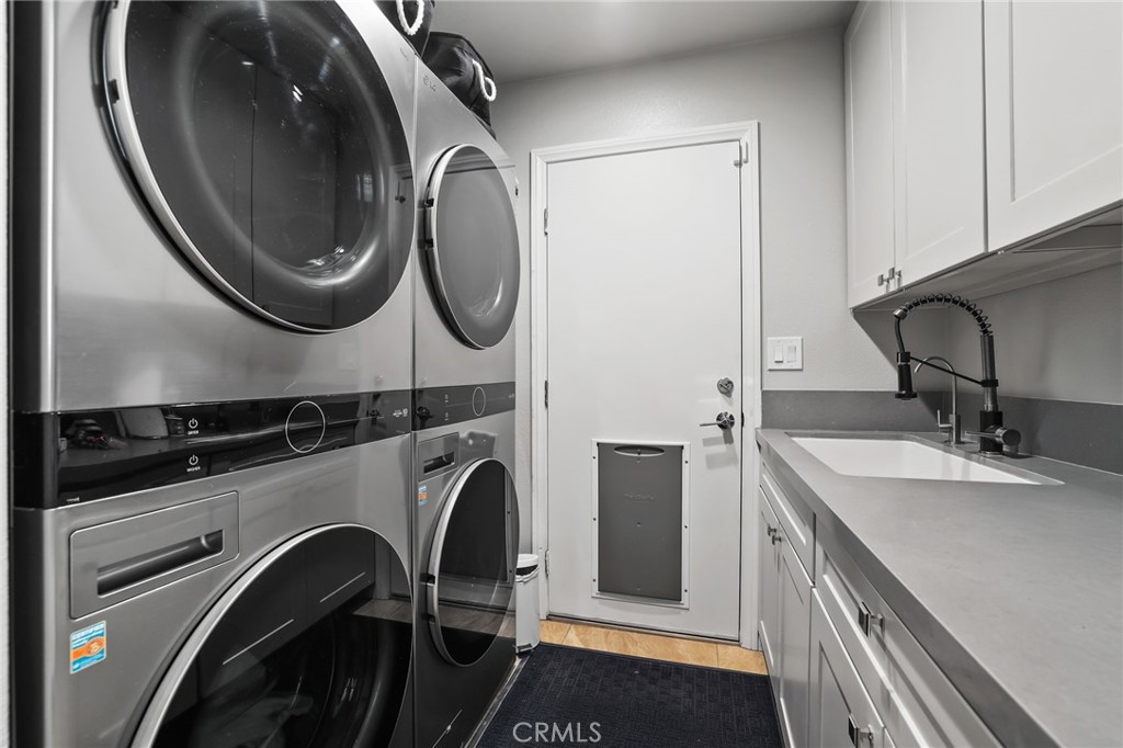 Interior Laundry Room offers twice as much fun~2 Washers, 2 Dryers and a sink~Leads to 3 Car Garage - 5 Mountain Gate, Coto de Caza CA 92679 - photo 28