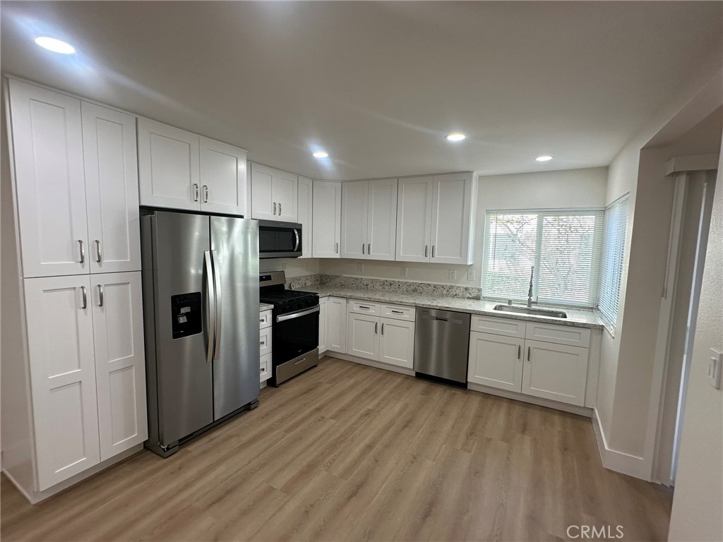 Fully remodeled with brand-new cabinets, countertops, and stainless-steel appliances. - 11382 Nantucket, Cypress CA 90630 - photo 1