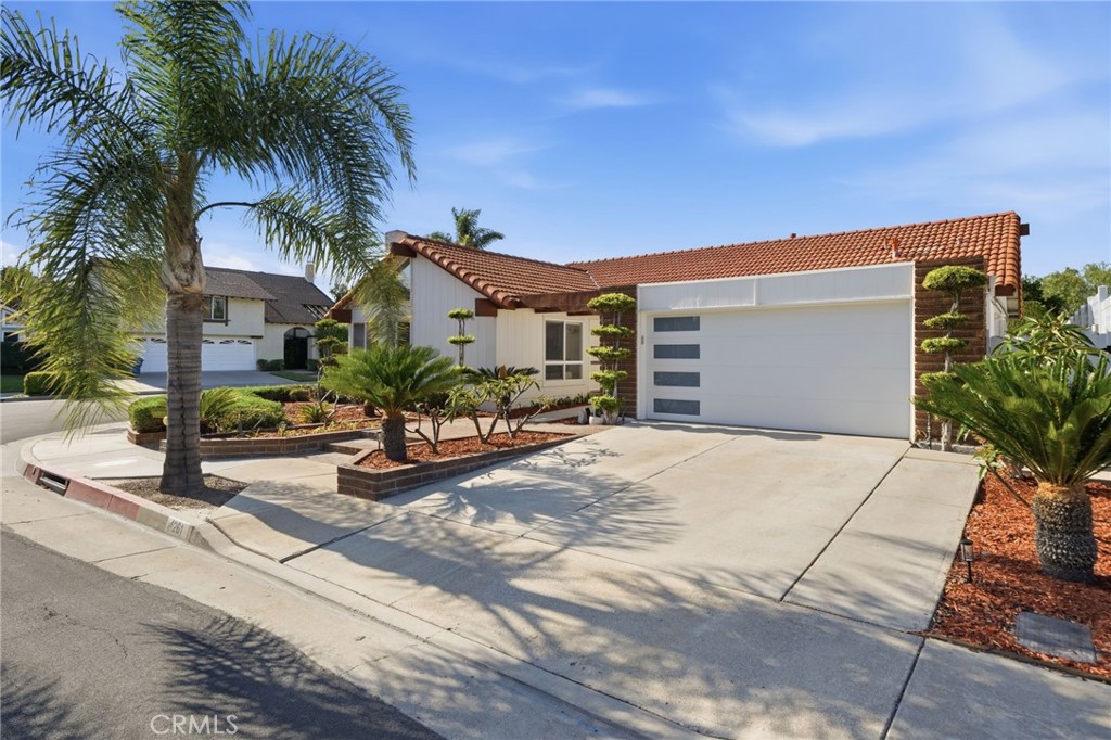 Beautifully upgraded and expanded Greenbrook Seville single-level pool home with Updated Custom Garage door with windows - 4261 LIVERMORE Place, Cypress CA 90630 - photo 1