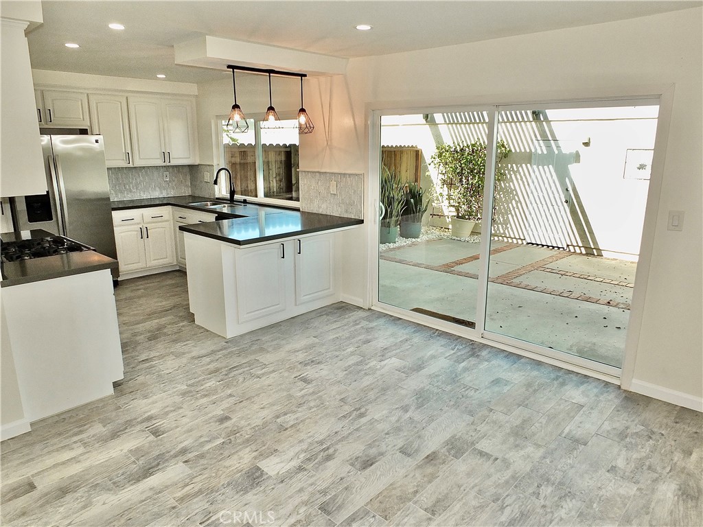 Dining Family Area to Kitchen with view to back patio - 6884 Breton, Cypress CA 90630 - photo 8