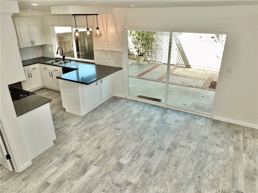 Dining/Family area to kitchen and patio - 6884 Breton, Cypress CA 90630 - photo 17