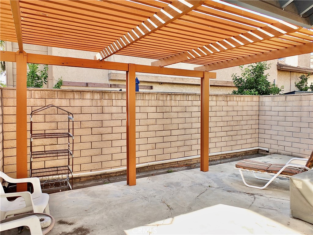 Large patio with slatted cover. - 8485 Kington Way 11, Cypress CA 90630 - photo 6