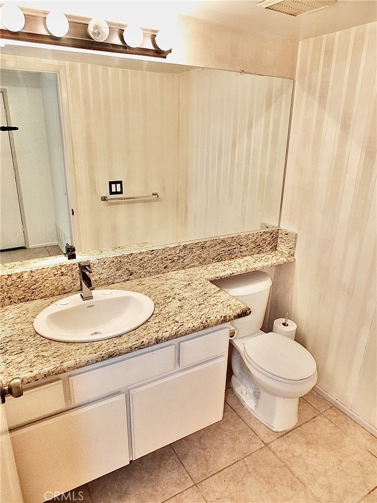 A first floor bathroom is so nice to have. - 8485 Kington Way 11, Cypress CA 90630 - photo 9