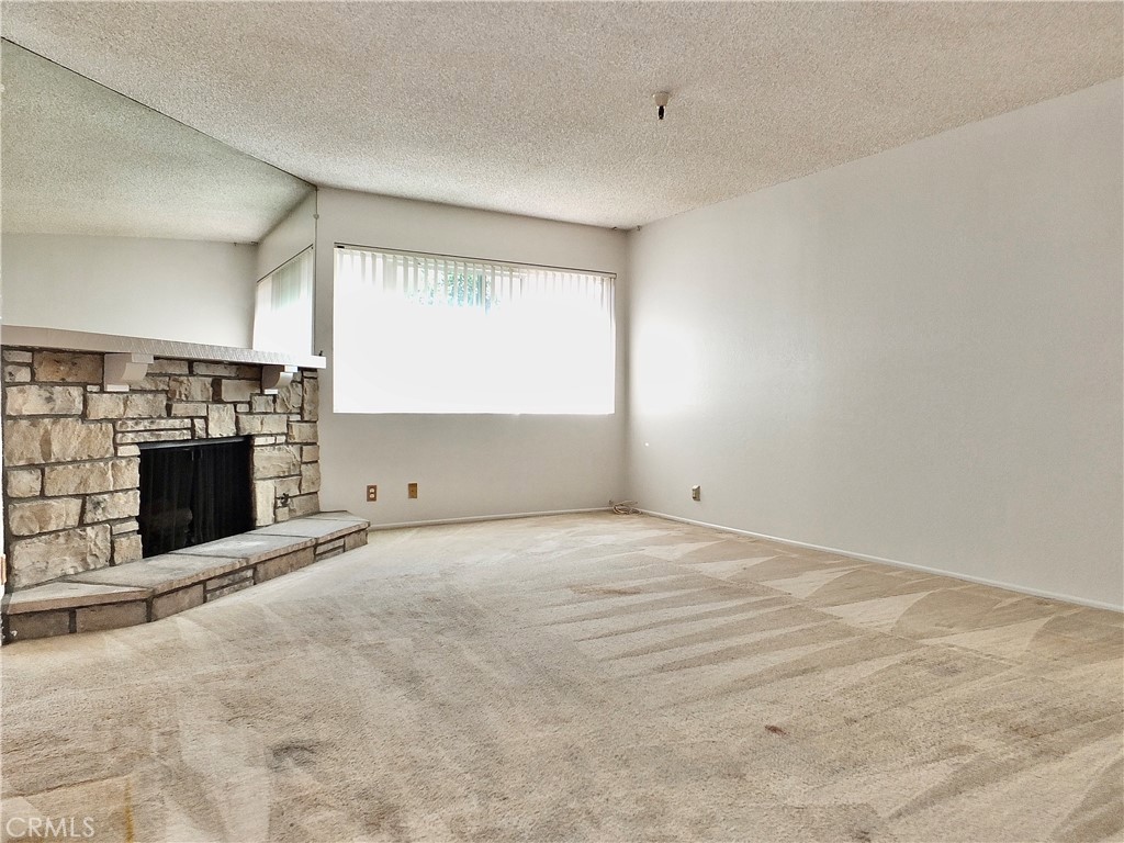 Large living room with fireplace. - 8485 Kington Way 11, Cypress CA 90630 - photo 10