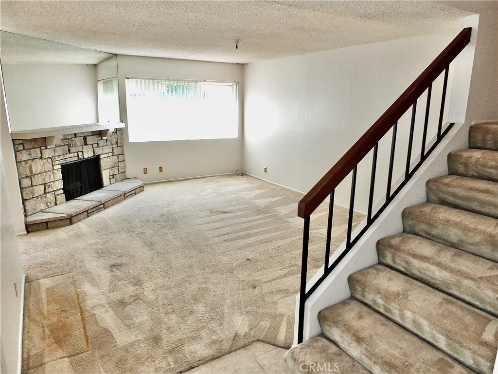 Living room with fireplace. - 8485 Kington Way 11, Cypress CA 90630 - photo 11
