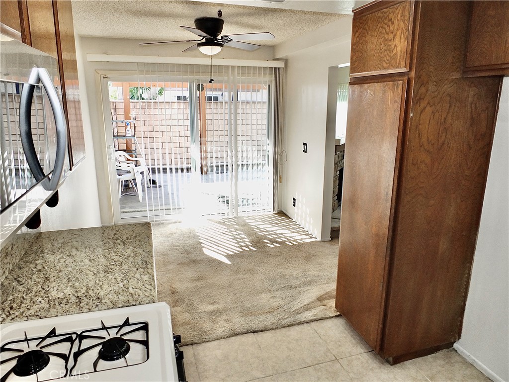 Access to kitchen from dining nook and foyer. - 8485 Kington Way 11, Cypress CA 90630 - photo 12