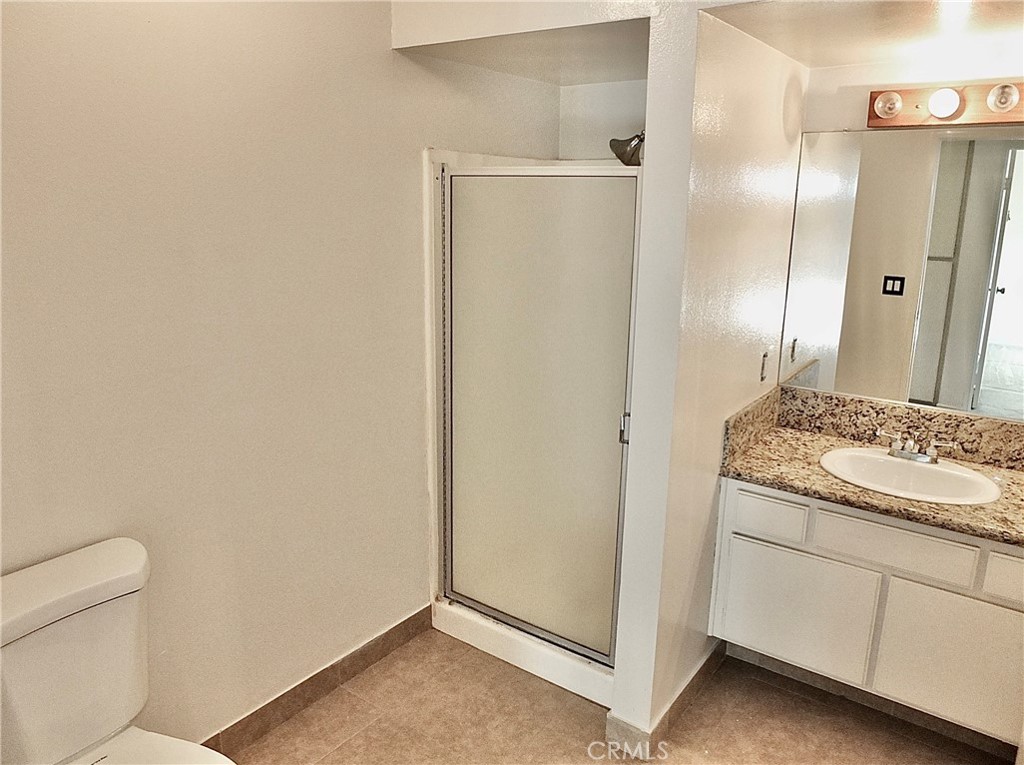 Secondary bathroom with shower stall. - 8485 Kington Way 11, Cypress CA 90630 - photo 15