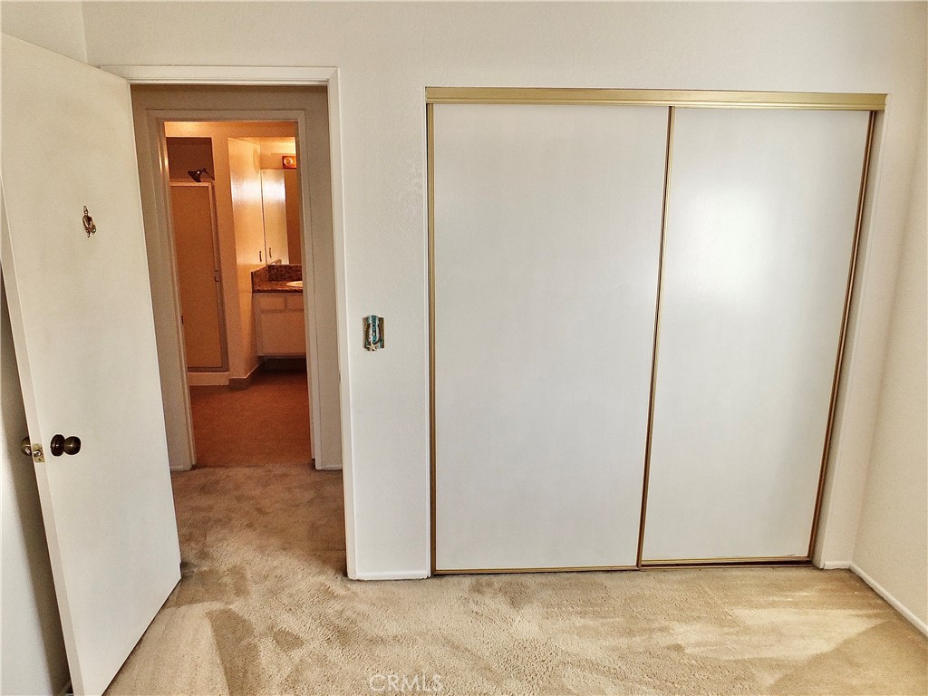 The second bedroom is across from the second bathroom. - 8485 Kington Way 11, Cypress CA 90630 - photo 16