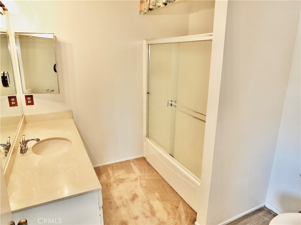The primary bathroom has a tub and shower combo. - 8485 Kington Way 11, Cypress CA 90630 - photo 21